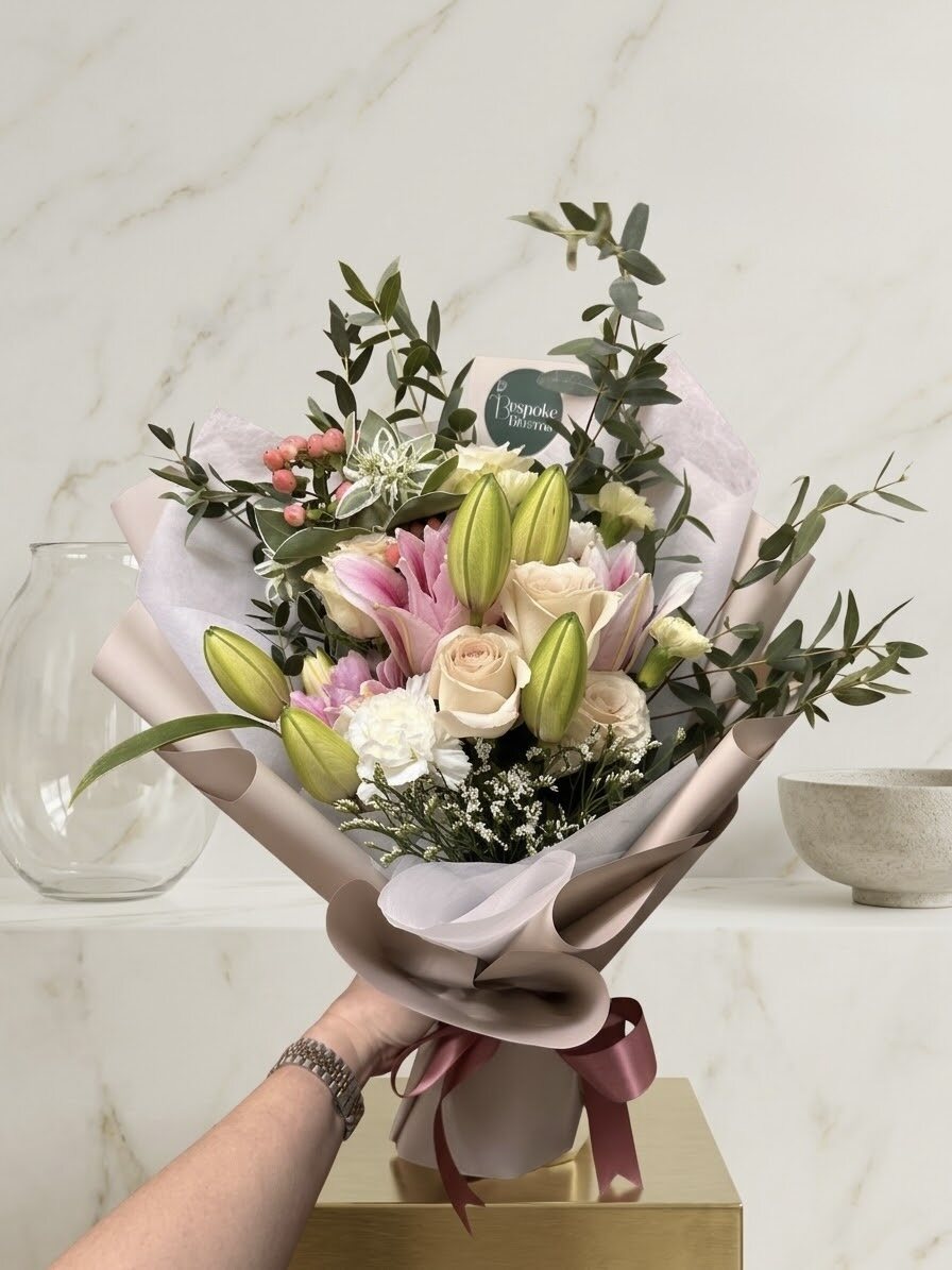 Aalsmeer - pink lily buds with cream roses and eucalyptus