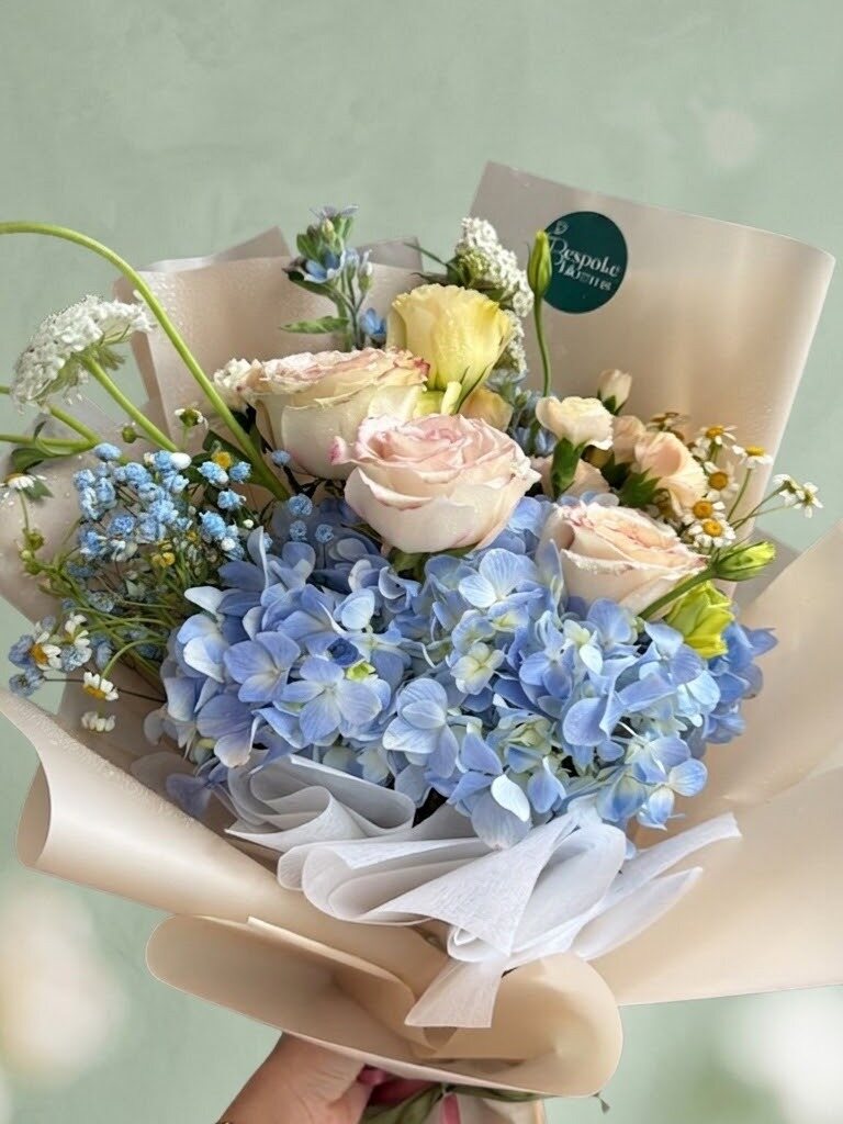 Madeira - blue hydrangea with roses and chamomile against a soft green background