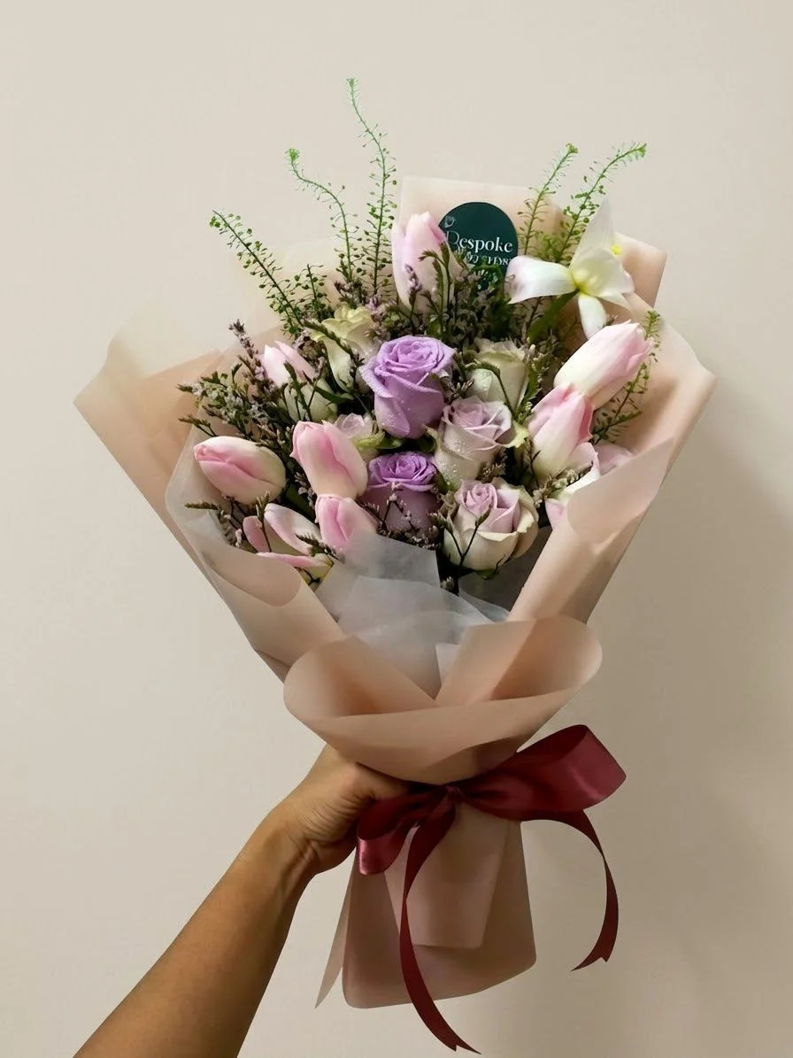 Pastel pink tulips with lilac roses, wrapped in kraft paper
