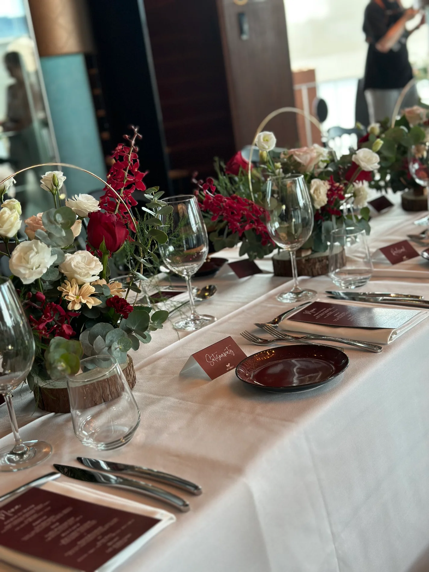 Red and white floral runner along a reception table